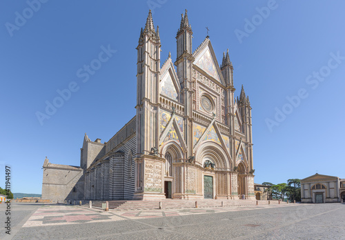Renaissance facade of Orvieto cathedral, with rose window and gothic style spires and sculptures, a famous landmark in Orvieto medieval town in Umbria, Italy