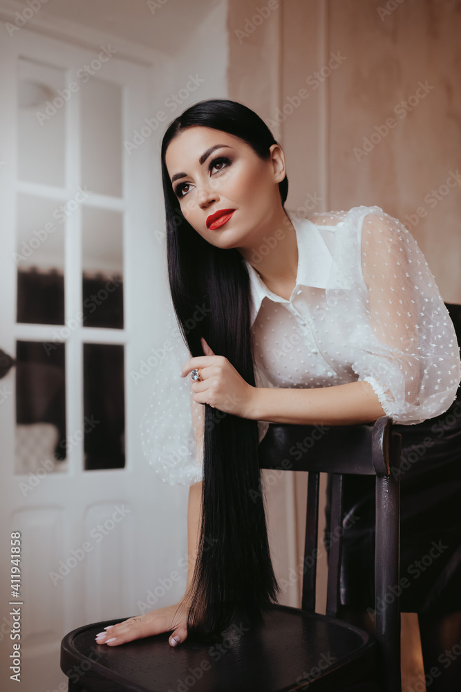 Fototapeta premium Photo of beautiful young woman in a casual clothes with black hair and red lips 