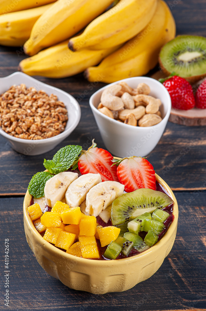 .Brazilian açaí in a bowl accompanied by tropical fruits. Fruit of the Amazon .Brazilian açaí in a bowl accompanied by tropical fruits. Fruit of the Amazon
