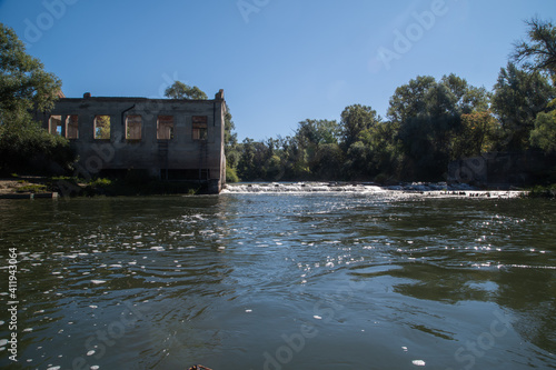Old mill on the Khopyor river. Destroyed dam and building. August on the river. Rafting and travel. Descent downstream.