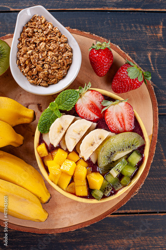 Brazilian açaí in a bowl accompanied by tropical fruits. Fruit of the Amazon. Top view