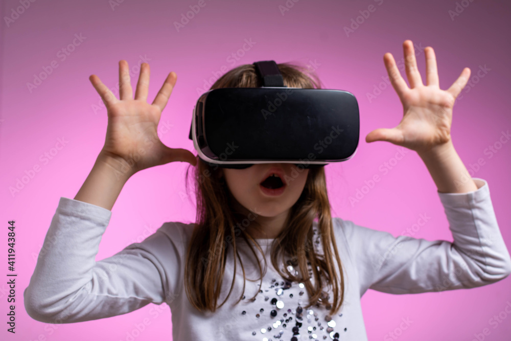 Kid in formal outfit wearing VR glasses putting hands out in excitement. Kid in formal outfit wearing VR glasses putting hands out in excitement.
