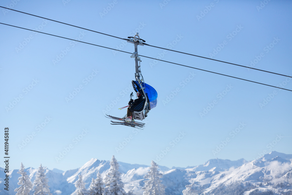 Ski lift above the mountain peaks. Ski resort in the Austrian Alps