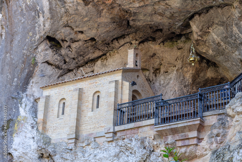 Covadonga, Spain - September 4, 2020: The Holy Cave, place where Our Lady of Covadonga appeared to Pelayo. The Santa Cueva de Nuestra Senora de Cuadonga is a Catholic sanctuary located in Asturias.