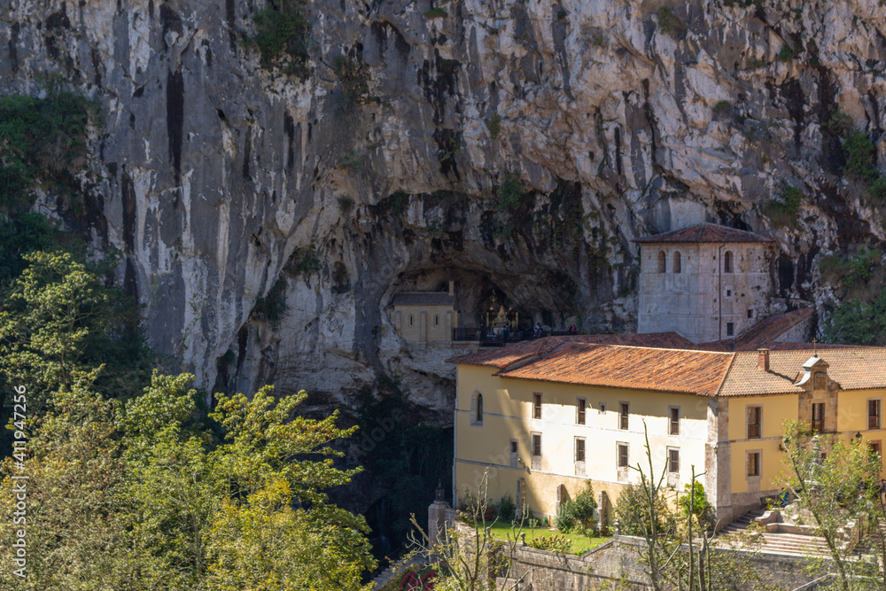 Covadonga, Spain - September 4, 2020: The Holy Cave, place where Our Lady of Covadonga appeared to Pelayo. The Santa Cueva de Nuestra Senora de Cuadonga is a Catholic sanctuary located in Asturias.
