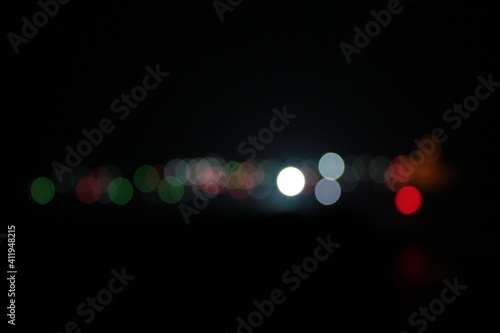 Abstract background of blurred warm lights with red and white. Bokeh effect © Uygar
