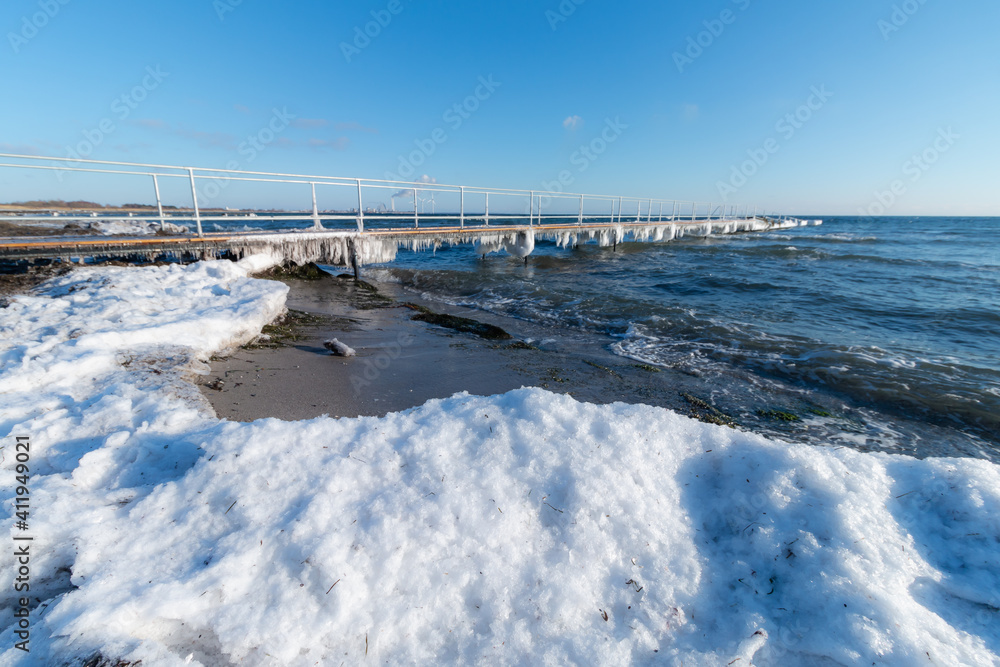 Frozen pier and snow in beach day time at Denmark