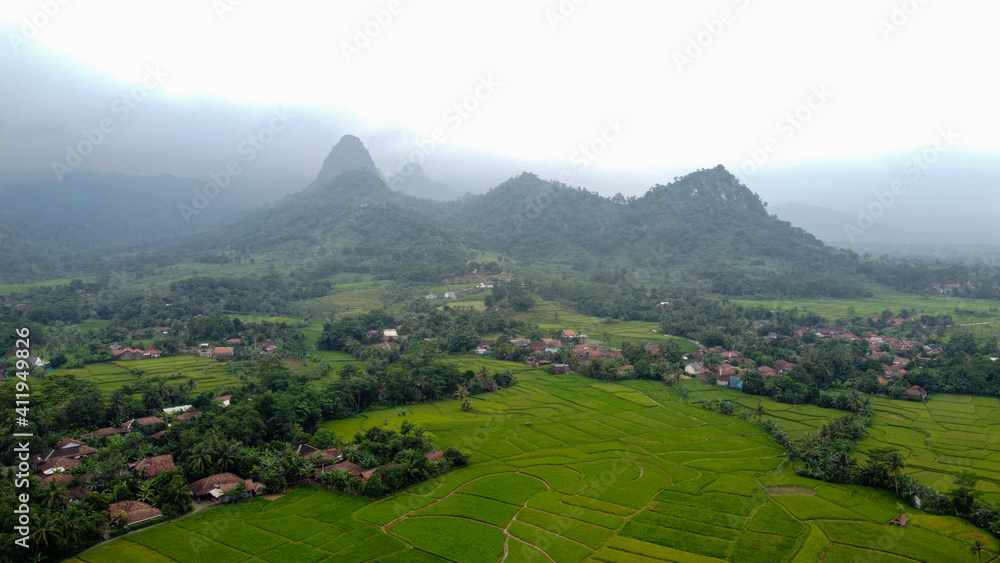 Aerial view of Rice fields on terraced of Cariu with noise cloud after rain, Bogor, Indonesia. Indonesia landscapes. Aerial view of Rice fields on terraced of Cariu with noise cloud after rain, Bogor, Indonesia. Indonesia landscapes.