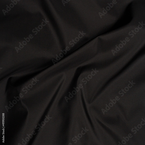 Smooth fabric texture with folds and wawes. Close up silk background