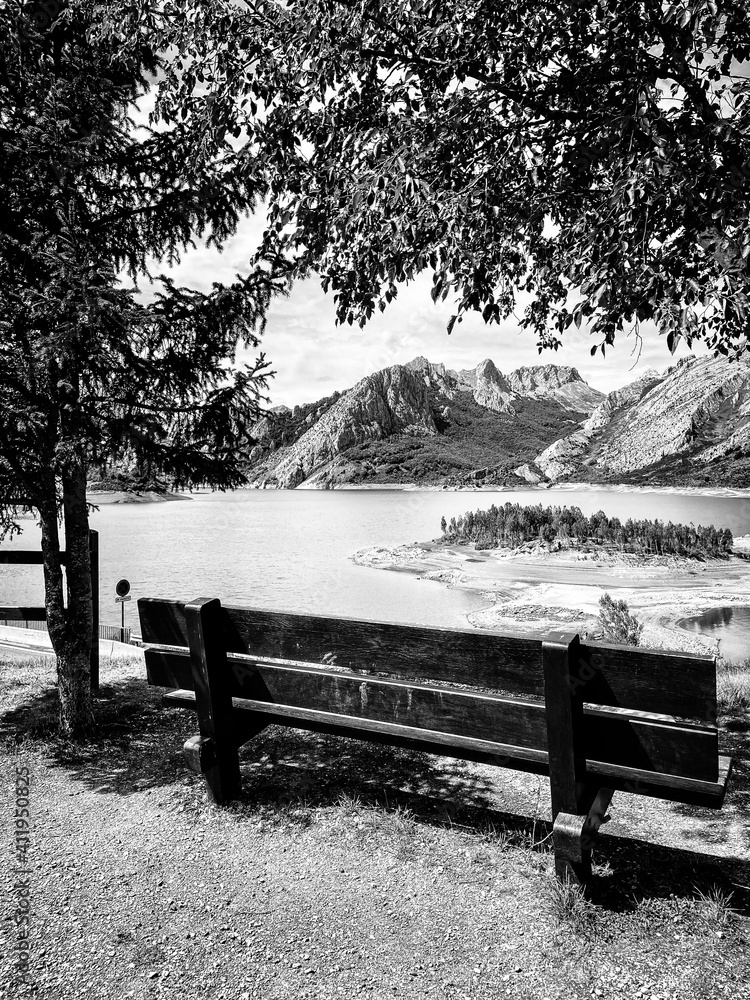 The best bench in Leon, Spain. The bench overlooks the Riano reservoir in Northern Spain. Yordas Peak towers over Riano, the Cantabrian Mountains, Castile-Leon region.