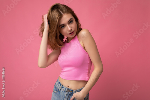 Photo of attractive cute sexy happy emotional young woman poising isolated on background wall with free space wearing trendy casual clothes © Ivan Traimak