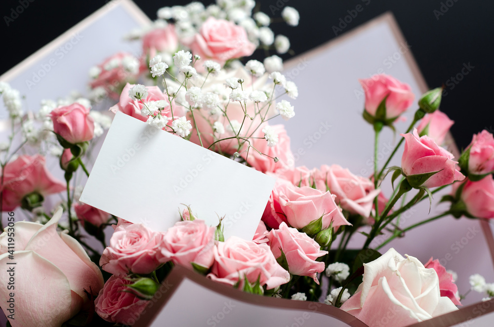 greeting card mockup in a bouquet of pink roses, close-up photo