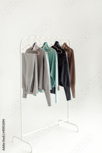 Stylish and comfortable clothes for teenagers hang on a hanger. Clothes for convenience on a white background