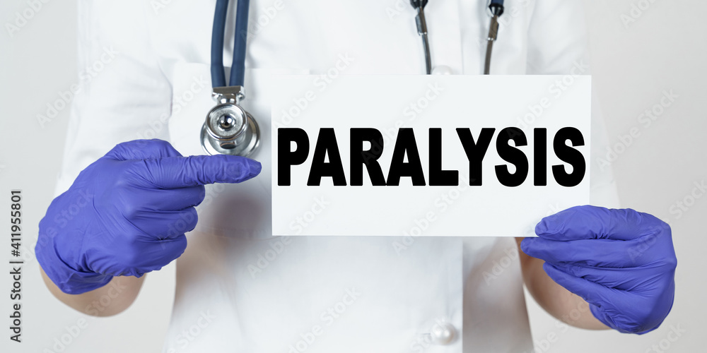 The doctor points his finger at a sign that says - PARALYSIS The doctor points his finger at a sign that says - PARALYSIS