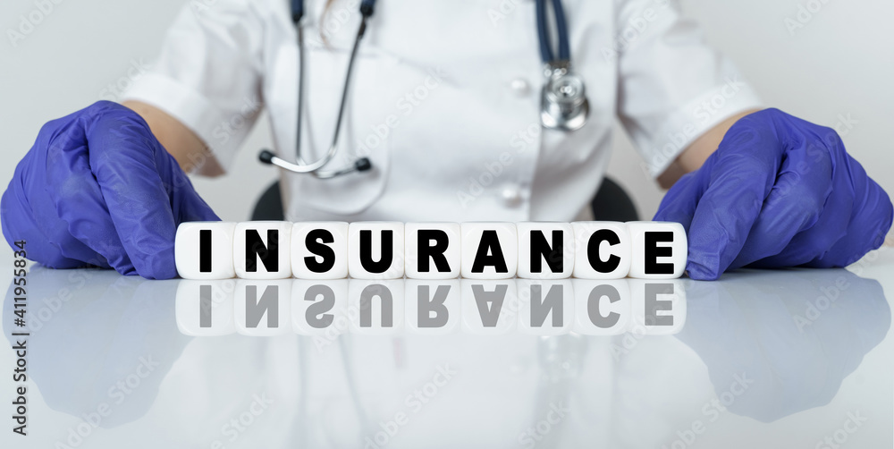 The doctor put together a word from cubes INSURANCE The doctor put together a word from cubes INSURANCE
