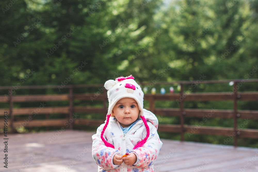 Portrait of little toddler girl having fun outdoors in cold weather at mountains Portrait of little toddler girl having fun outdoors in cold weather at mountains