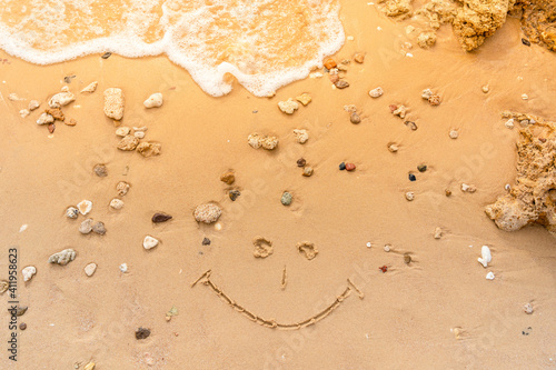 Fototapeta Naklejka Na Ścianę i Meble -  Smile painted on the sandy beach