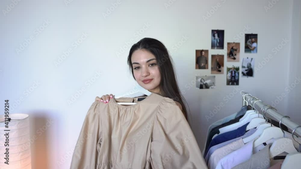 Attractive brunette woman is Looking for What to Wear. Thinking How to Put Together an Outfit. Attractive brunette woman is Looking for What to Wear. Thinking How to Put Together an Outfit.