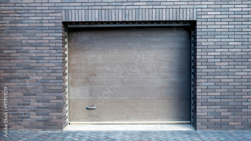 lifting garage doors in a brick building.