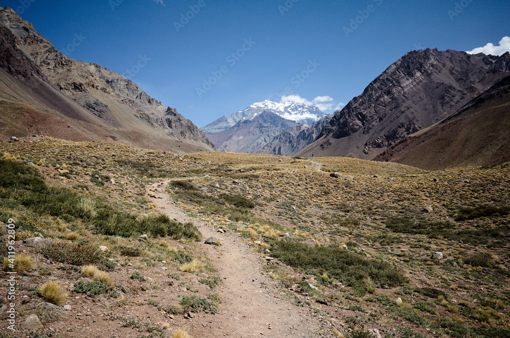 Andes Mountains landscape with hiking trail with no people and view to Aconcagua Peak. Aconcagua provincial park, Mendoza province, Argentina
