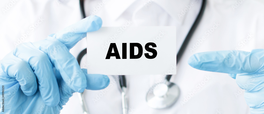 doctor's hands are holding card with text AIDS, closeup of hands in blue styryl gloves. Medical concept on white background doctor's hands are holding card with text AIDS, closeup of hands in blue styryl gloves. Medical concept on white background