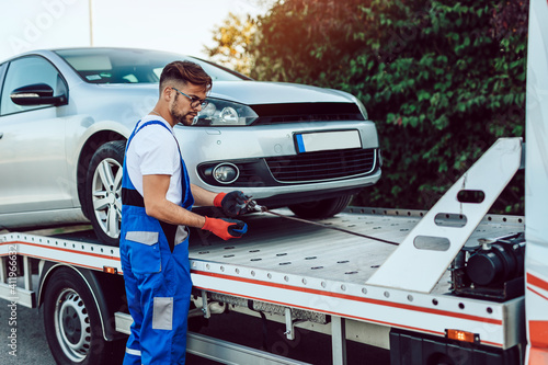 Tableau sur toile Handsome middle age man working in towing service on the road