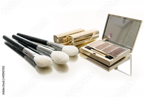 Brush and cosmetic isolated on a white
