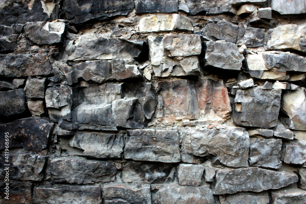 An old burnt-out wall made of limestone blocks. An old burnt-out wall made of limestone blocks.