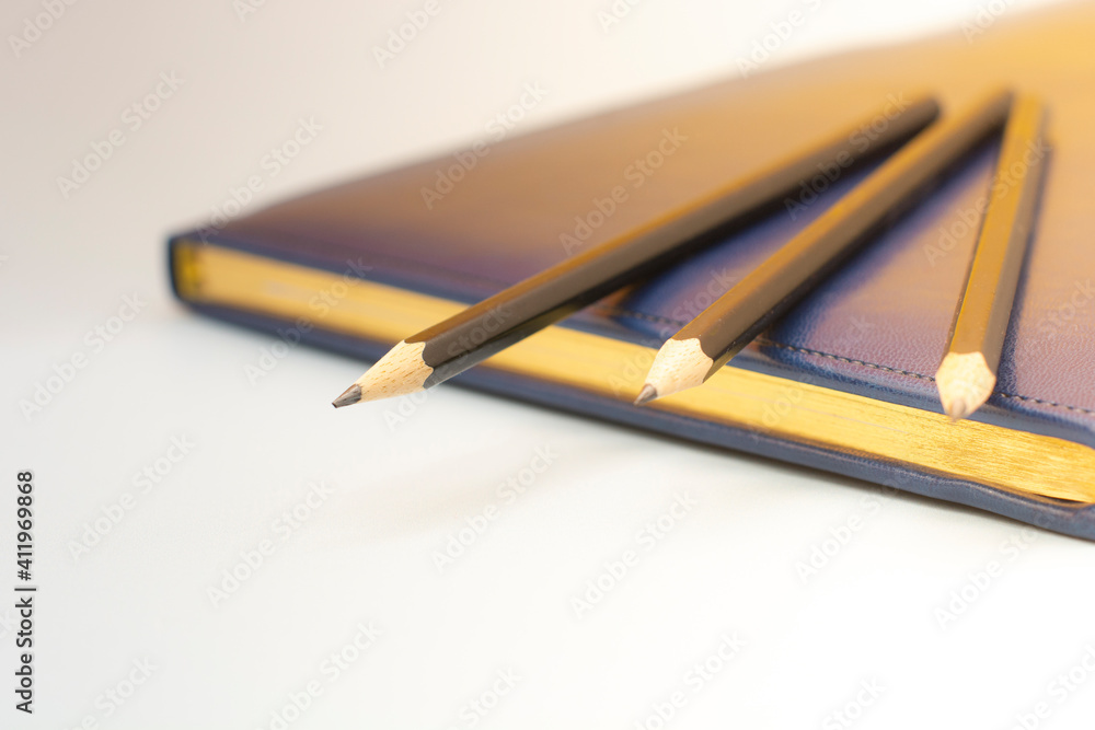 dark blue leather notebooks and three pencils. Preparing for a business meeting. Business concept dark blue leather notebooks and three pencils. Preparing for a business meeting. Business concept