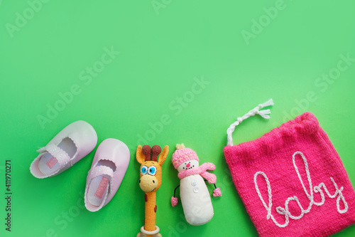 children's shoes on a green background top view. space for the text. children's slippers.