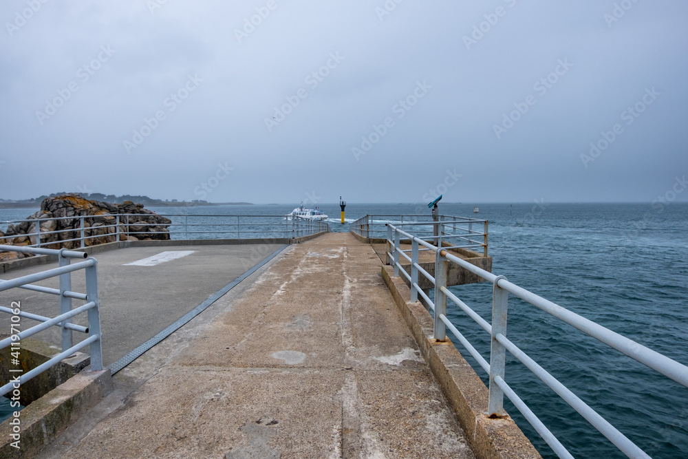 Roscoff, France - August 28, 2019: The beacon of pontoon jetty. Ferry walkway to Ile De Batz at Roscoff. Bridge leads to the deep water Ferry Terminal