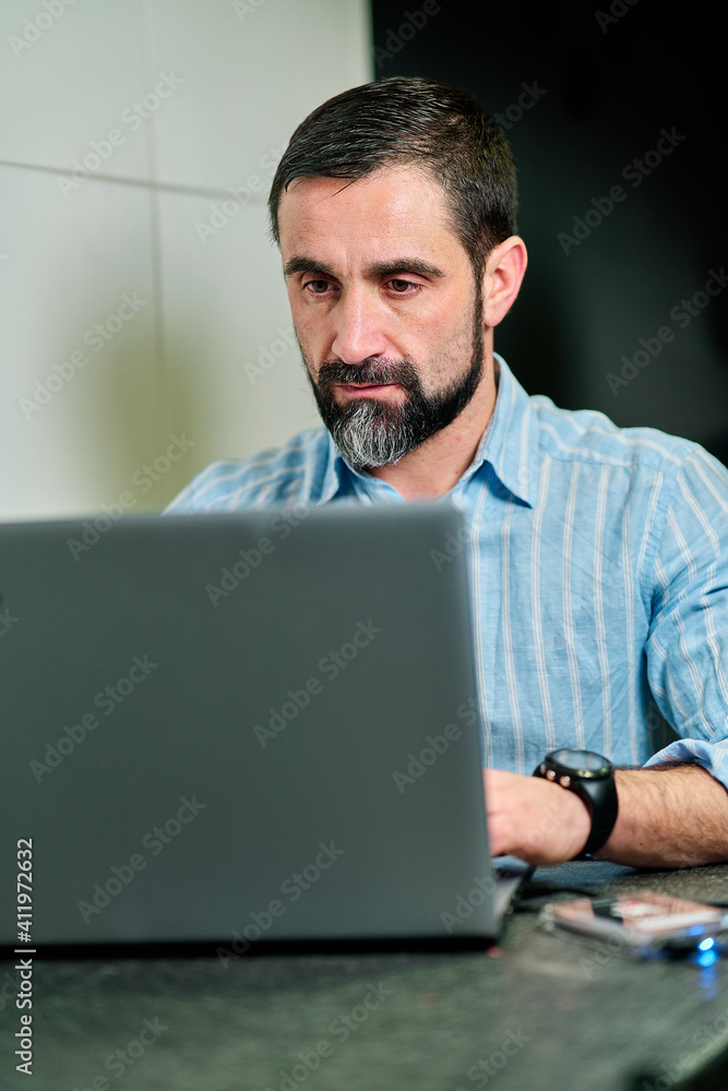 white man with beard working on laptop concentrated white man with beard working on laptop concentrated