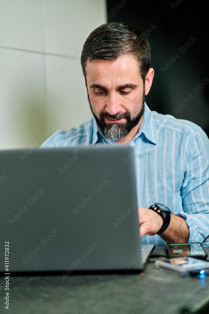 white man with beard in smiling attitude typing on computer white man with beard in smiling attitude typing on computer