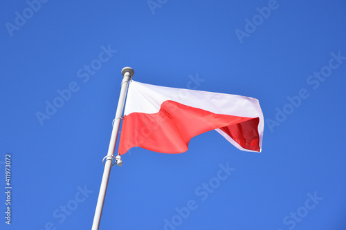 Poland, Polish national flag waving on a pole, close up