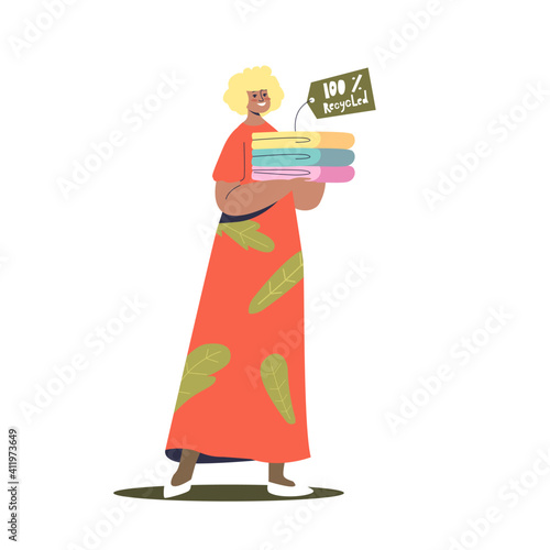 Woman holding stack of recycled eco friendly clothes. Sustainable fashion concept