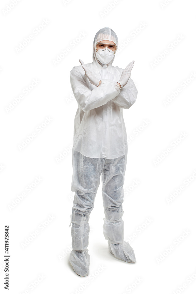 Male doctor in chemical protection in full height shows no, hands crossed. He looks at the camera. White isolated background. Male doctor in chemical protection in full height shows no, hands crossed. He looks at the camera. White isolated background.