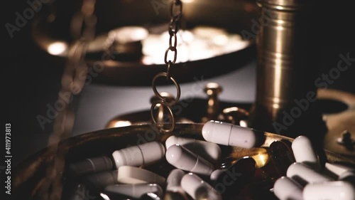 weighing scales with pills and coins