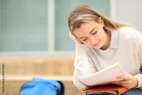 Student studying memorizing notes in a campus photo