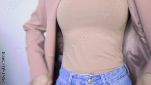 Girl is unbuttoning the Jacket