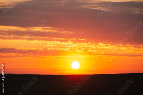 Magical colorful sunset with red scenic clouds.