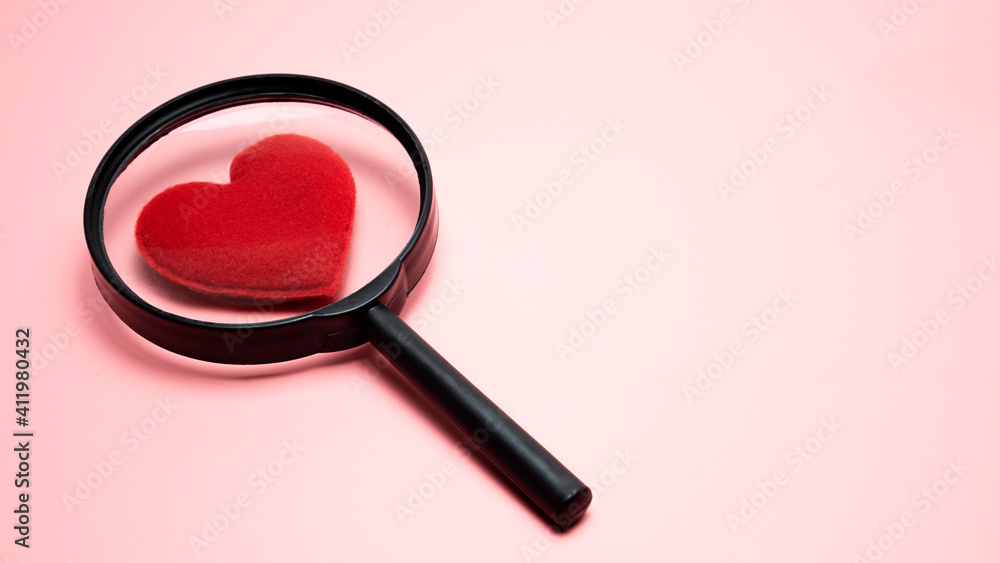 Heart shaped magnifying glass on pink background, Finding True Love Valentine concept. Heart shaped magnifying glass on pink background, Finding True Love Valentine concept.