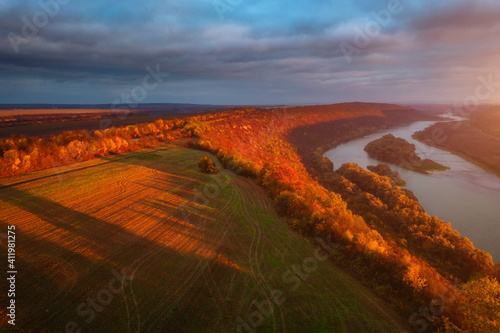 Beautiful top view of winding river in sunset. Scenic image of drone photography. © Leonid Tit