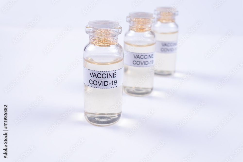 three ampoules with the Covid-19 vaccine are in a row