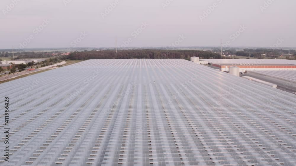 Modern farming concept. Aerial view of big glasshouse. Environmental friendly farming, huge plantation, future agriculture. Modern farming concept. Aerial view of big glasshouse. Environmental friendly farming, huge plantation, future agriculture.
