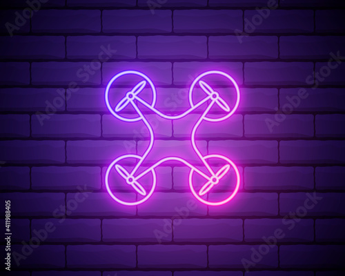 Neon drone in pink colour. Vector illustration of quadrocopter consisting of neon outlines, with backlight on the brick wall background