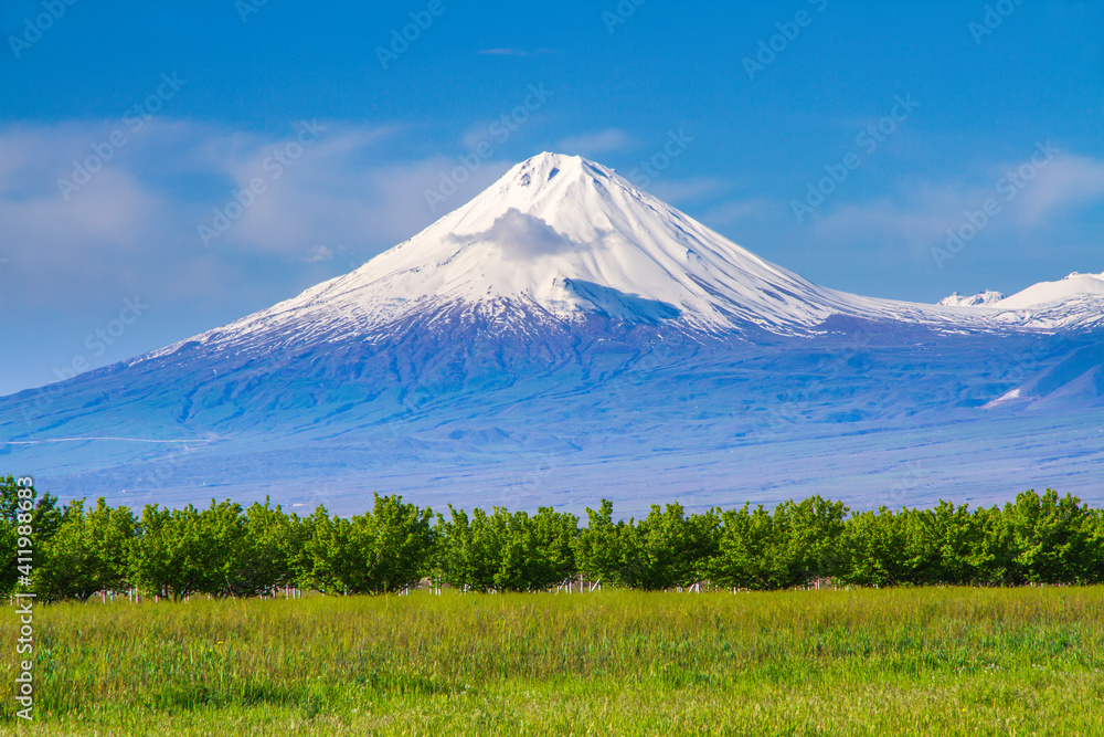 Fototapeta premium Mount Ararat (Turkey) at 5,137 m viewed from Yerevan, Armenia. This snow-capped dormant compound volcano consists of two major volcanic cones described in the Bible as the resting place of Noah's Ark.