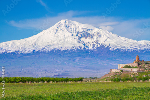 Awe-Inspiring medieval Khor Virap monastery in front of Mount Ararat viewed from Yerevan, Armenia. This snow-capped dormant compound volcano described in the Bible as the resting place of Noah's Ark.