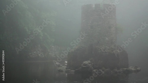 Castled Tower in the middle of lake on foggy day