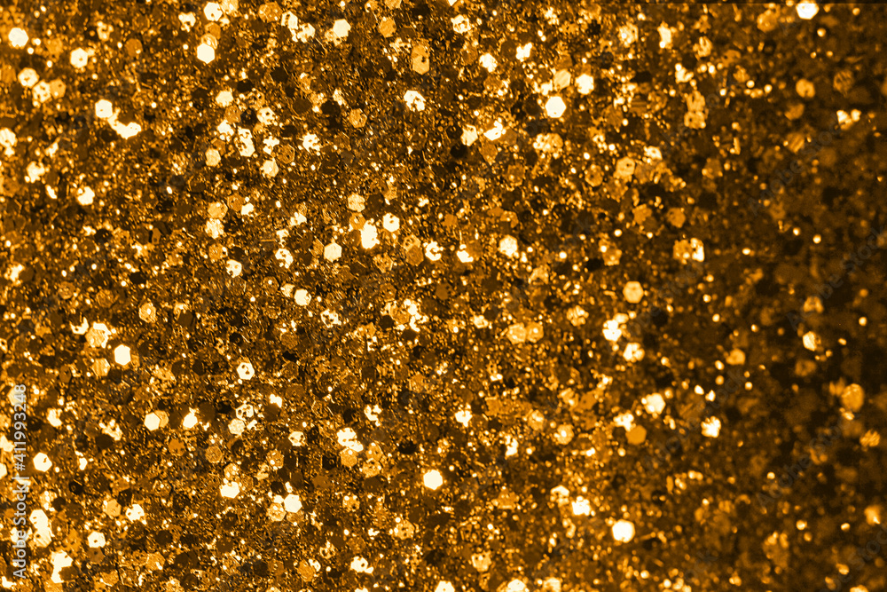 Gold defocused glitter. Bokeh light of gold glitters background. Gold defocused glitter. Bokeh light of gold glitters background.