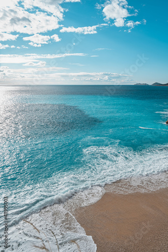 Fototapeta Naklejka Na Ścianę i Meble -  High angle clifftop view turquoise water and nobody on white sand beach Kaputas, Turkey. 
